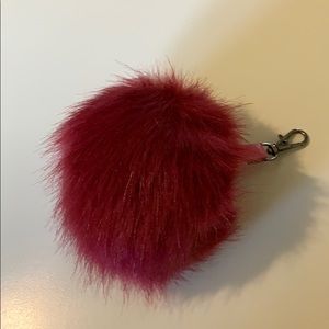 Red puffball bag accessory